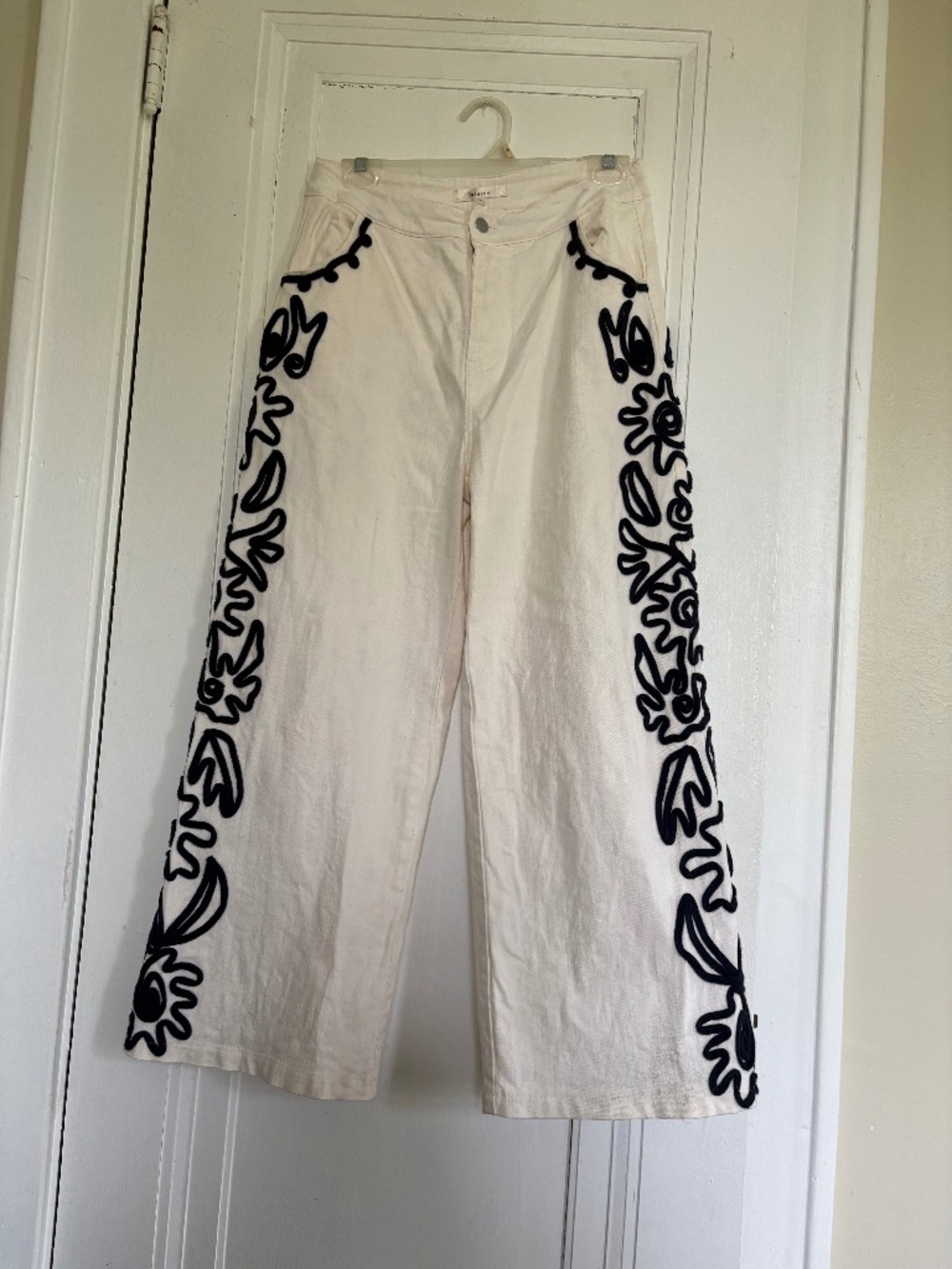 Women’s white denim pants with blue embroidery